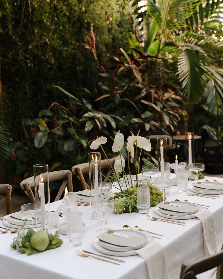 Modern minimalist candlelit table with white anthurium florals