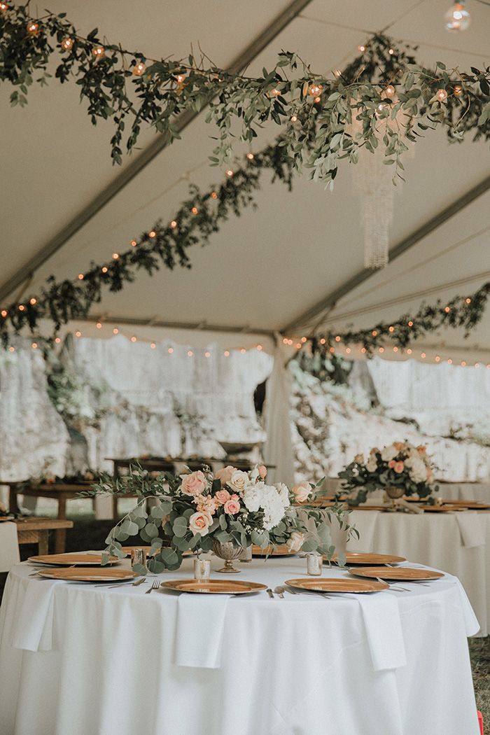 Tented reception table with hanging greenery and string lights