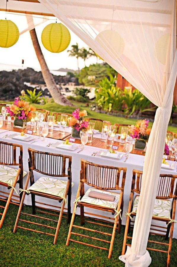Bamboo chairs and lanterns at a tropical reception