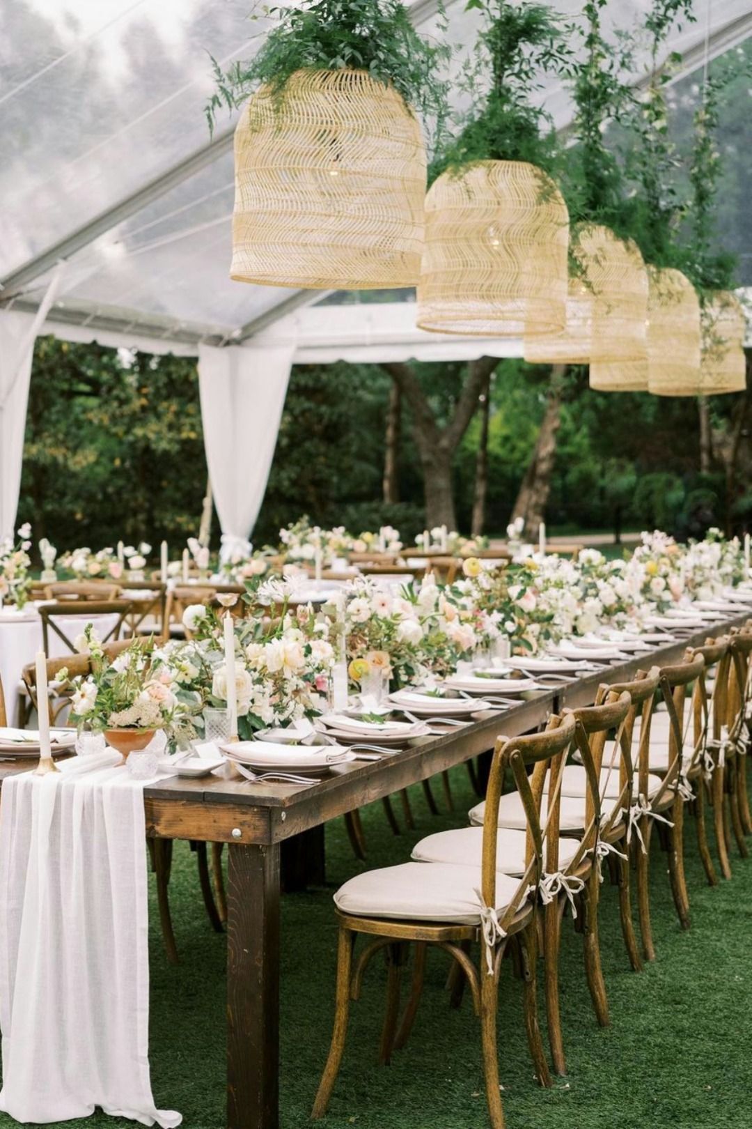 Rattan pendant lights over a floral reception table