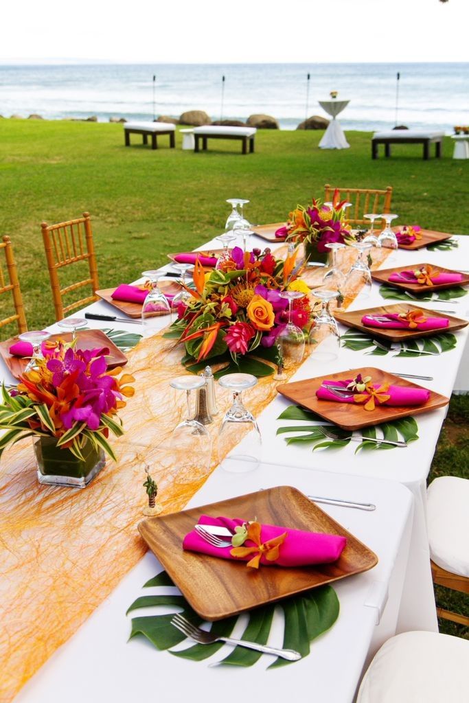 Oceanfront table setting with colorful tropical florals